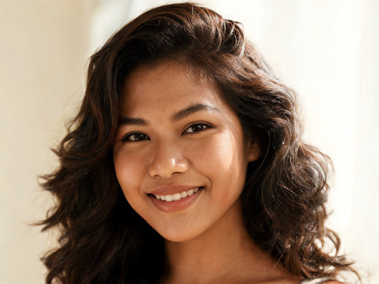 Woman using an Amstar hot air brush for a smooth salon-style blowout at home
