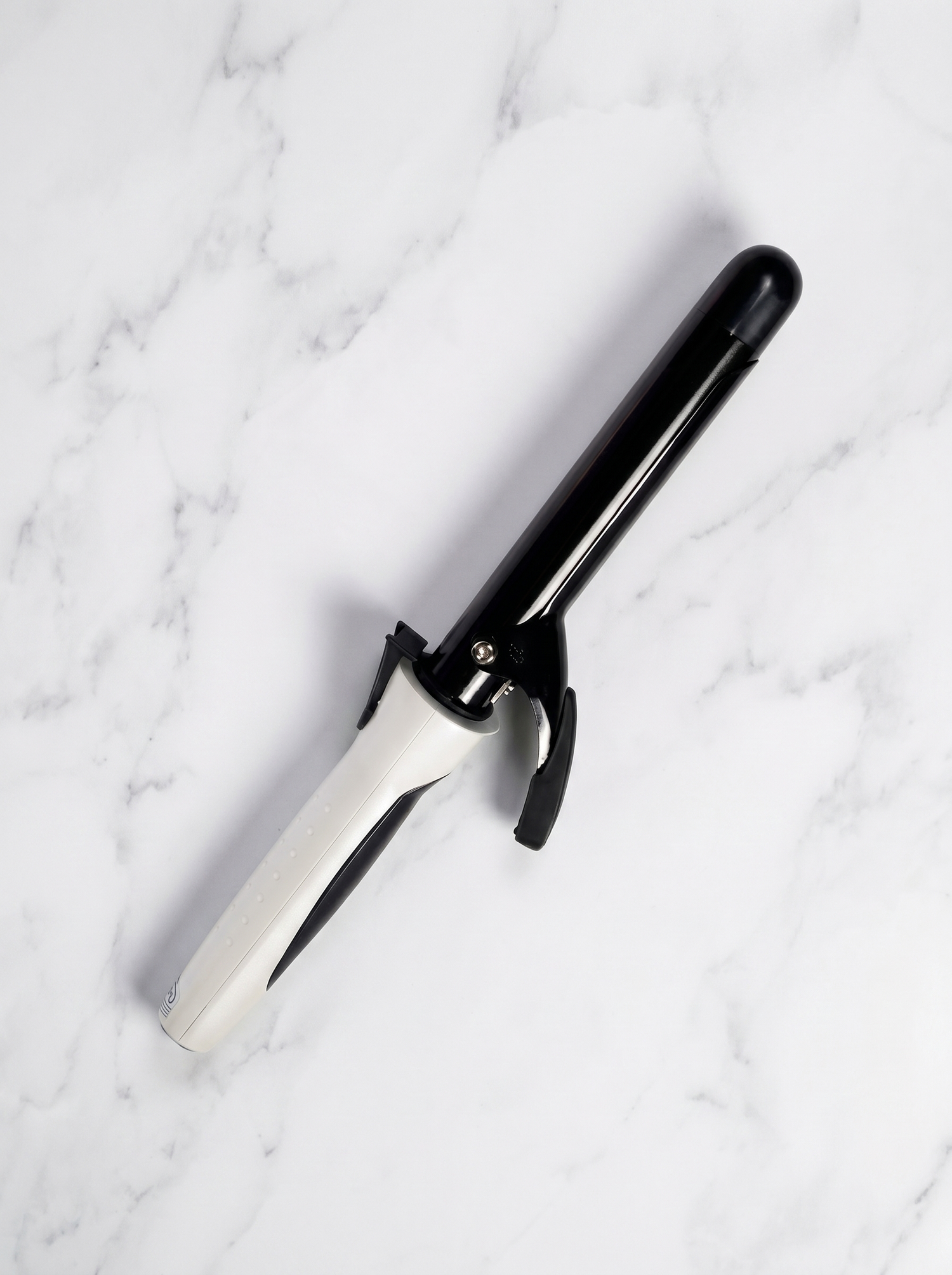 Amstar curling irons on white marble