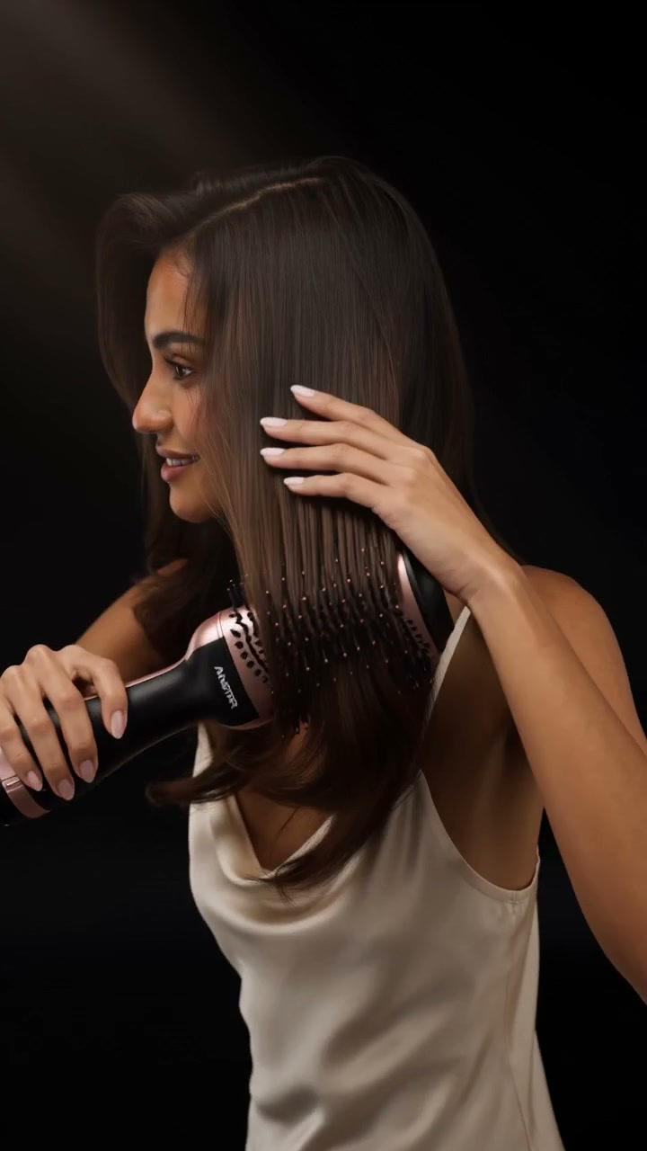 Filipina styling her hair with the Amstar rose-gold volumizing brush